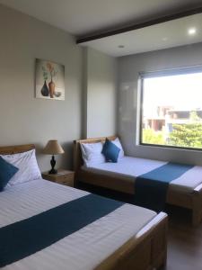 Postel nebo postele na pokoji v ubytování Bao Tran Homestay