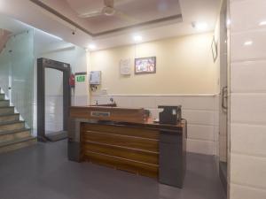 a hospital room with a reception desk and stairs at Hotel Grace, Karol Bagh, New Delhi in New Delhi