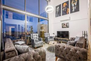 a living room filled with furniture and a large window at Deniz gören lüks yeni eşyalı ferah 4+1 özel villa in Kas