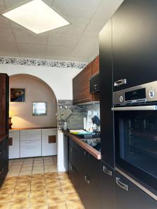 a kitchen with black cabinets and an oven at Magnolia in Garmisch-Partenkirchen