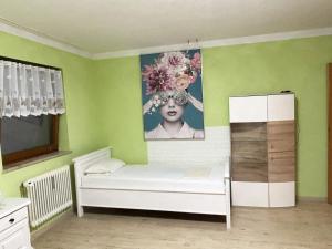 a room with a bed and a painting on the wall at Magnolia in Garmisch-Partenkirchen