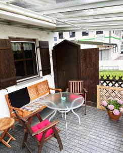 a patio with a table and chairs on a patio at Magnolia in Garmisch-Partenkirchen