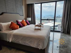 a bedroom with a large bed with a large window at The Platinum 2 KLCC Premium Suite by Reluxe Kuala Lumpur in Kuala Lumpur