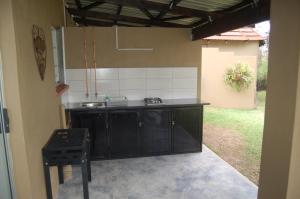 an outdoor kitchen with a sink and a stove at Nita's Air Bed & Breakfast & self catering in Crocodile Valley Estates