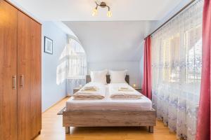 a bedroom with a bed and a window at Casa David in Săcele