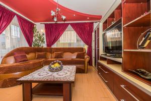 a living room with a couch and a table at Casa David in Săcele