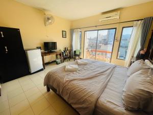 a bedroom with a large bed and a balcony at Sofia Hotel in Hua Hin