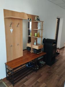 a room with a wooden desk and a tv at Apartman Veronika v rodinnom dome in Snina