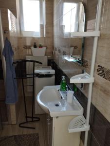 a bathroom with a sink and a toilet at Apartman Veronika v rodinnom dome in Snina