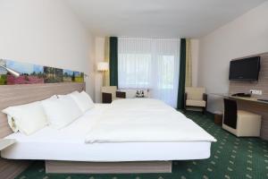 מיטה או מיטות בחדר ב-Jeddinger Hof Land- und Seminarhotel