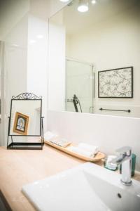 a bathroom with a sink and a mirror at Harmony Boutique Hotel in Drawsko Pomorskie