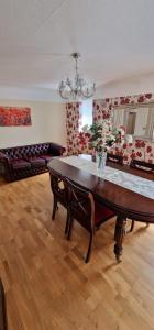 a living room with a table and a couch at Linksway House in Birkenhead