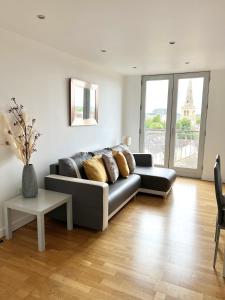 a living room with a couch and a table at Bedford Central Apartment with Free Secure Parking in Bedford