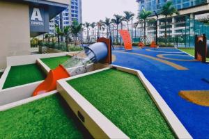 a playground in a building with a slide and grass at New! Bali 5-8pax Melaka Town @ Play View Condo in Melaka