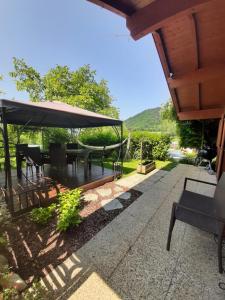 a patio with a table and chairs and an umbrella at Landhaus Manjul in Rammersdorf