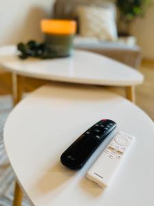 a remote control sitting on top of a table at Home Cinema - Balcony - Wi-Fi & Streams in Magdeburg