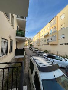 a row of cars parked in a parking lot next to buildings at Luz y brisa in Oropesa del Mar