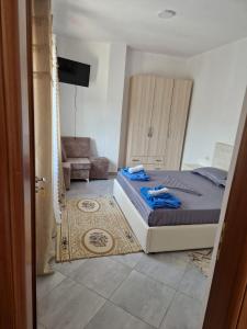 1 dormitorio con 1 cama y 1 silla en Bar-Restaurant-Hotel-Familja, en Klos