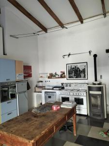 a kitchen with a wooden table in a room at La Fiaba del Monferrato in Vignale Monferrato