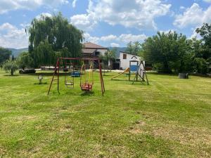 an empty park with a swing set in the grass at Agriturismo San Marco in Dragoni