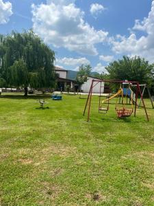 a park with a swing set in the grass at Agriturismo San Marco in Dragoni +5 photos