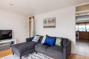 a living room with a couch and a tv at Spacious Room by Lee Valley White Water Centre. Waltham Cross in Waltham Cross