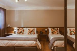 Postel nebo postele na pokoji v ubytování Hotel Patriarchi