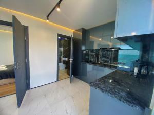 a kitchen with blue walls and a counter top at Black Diamond Sevan in Sevan