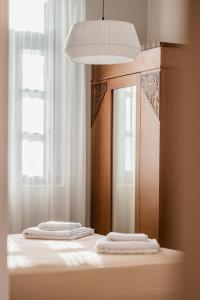 two towels sitting on top of a bed with a mirror at Villa Kalliopi in Chania Town