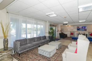 a large living room with a couch and chairs at Waterfront, Pool, Tiki Bar & Grill, Gym, location! in Sarasota