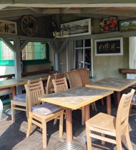 a wooden table and chairs in a restaurant at Wczasowisko Międzywodzie in Międzywodzie