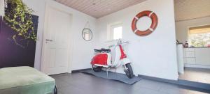 a red scooter is parked in a room at Villa Vandkant in Thyholm
