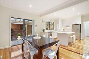 a kitchen and dining room with a table and chairs at Comfortable homestay in Clayton North