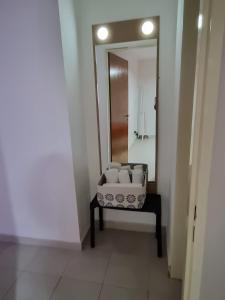 a bathroom with a mirror and a chair in a room at Home in Río Cuarto