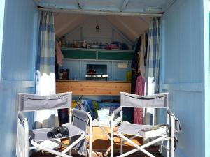 two chairs and a table in a blue room at Two rivers reach in Iford