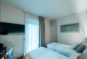 a hotel room with two beds and a window at Airport BEA Rooms in Azzano San Paolo +42 photos