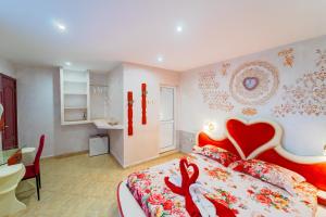 a bedroom with a bed with a red heart on it at Boutique Guest House 'Sofia' in Nesebar