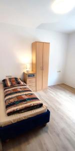 a bedroom with a bed and a dresser in it at Zur Elster 1 in Plauen