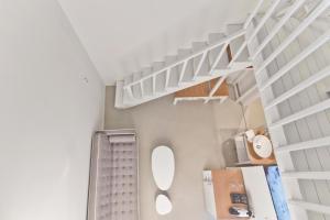 a bathroom with white shelves and a white staircase at Lindos Comfy Suites in Líndos