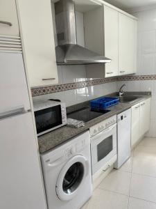 a kitchen with a washing machine and a sink at Preciosa casa en Castro Urdiales in Castro-Urdiales