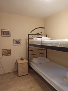 a bedroom with two bunk beds and a night stand at ''Shinohori'' Olive-Tree Apartment in Argos