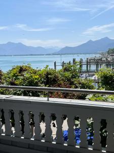 a balcony with a view of a body of water at Sieben Zimmer am See in Prien am Chiemsee