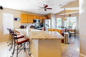 a kitchen with a large island with bar stools at Gold Canyon Getaway in Gold Canyon