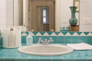 a bathroom counter with a sink and a mirror at Cianis Home San Marco - Apartment in Venice