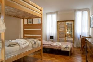a bedroom with two bunk beds and a mirror at Cianis Home San Marco - Apartment in Venice