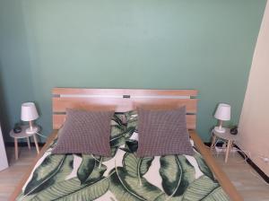 a bedroom with a bed with two pillows on it at Maison de village, charmante et authentique, haute-corse in Vezzani