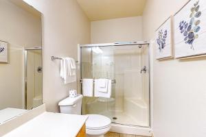 a bathroom with a toilet and a glass shower at Wildwood Adventures - Unit B in Branson