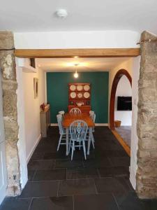 a dining room with a table and chairs at The Old Barn in St Ives +20 photos