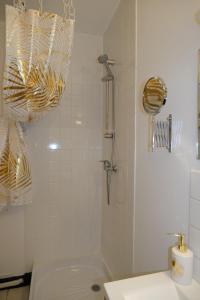 a bathroom with a shower with a toilet and a sink at Le Jockey - SIPCO Immobilier - Centre in Saint Lo