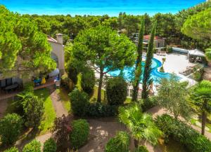 eine Luftansicht eines Resorts mit Pool und Bäumen in der Unterkunft Villaggio Mare Blu in Bibione